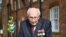 British World War II veteran Captain Tom Moore, 99, walks a lap of his garden in the village of Marston Moretaine, 50 miles north of London, April 16, 2020.