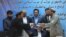 Afghanistan Peace Deal: Amin Karim, representative of Gulbuddin Hekmatyar, right, and Attaurahman Saleem, head of delegation of peace talks, left, exchange documents after signing a peace deal in Kabul, Afghanistan, Thursday, Sept. 22, 2016.