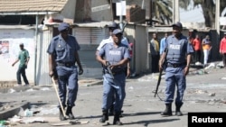 FILE PHOTO: Police patrol the streets after overnight unrest and looting in Alexandra township, Johannesburg, South Africa, September 3, 2019. REUTERS/Marius Bosch/File Photo