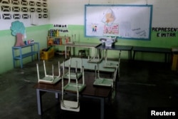 Empty desks are seen in a classroom on the first day of school, in Caucagua, Venezuela, Sept. 17, 2018.