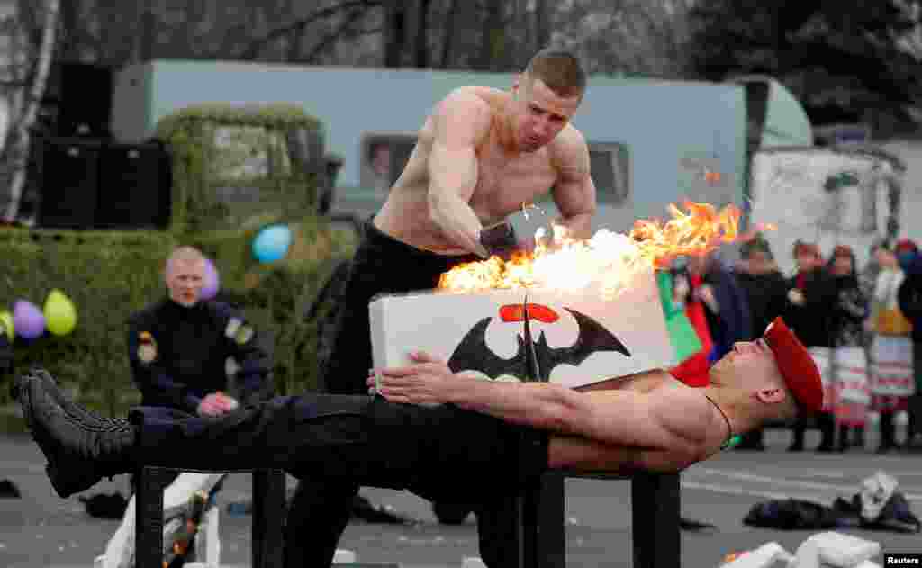 Servicemen of the Belarusian Interior Ministry's special forces unit show off their skills during celebrations of Maslenitsa, or Pancake Week, marking the end of winter at a base in Minsk, Belarus.