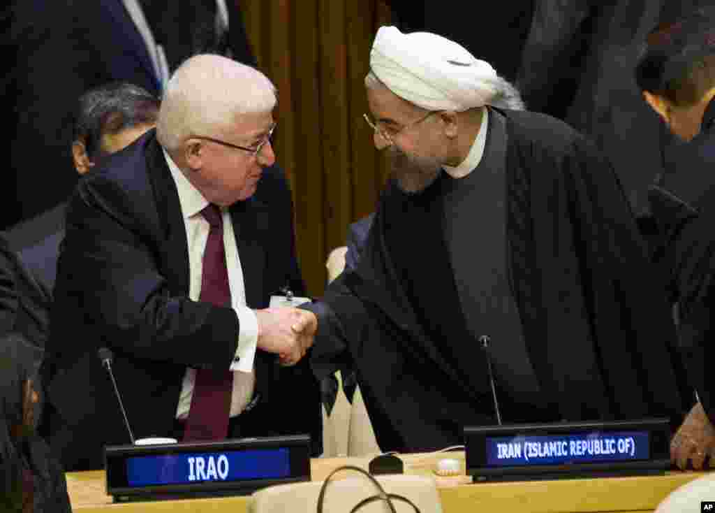 Iraq&#39;s President Fuad Masum (left) is greeted by Iranian President Hassan Rouhani as he arrives at the Climate Summit 2014 at U.N. headquarters, Sept. 23, 2014. 