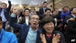 Supporters of the presidential candidate Moon Jae-in of the Democratic Party react as they watch televisions broadcasting results of exit polls for presidential election at National Assembly in Seoul, South Korea, May 9, 2017.