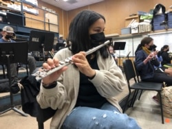 A student plays the flute while wearing a protective face mask during a music class at the Sinaloa Middle School in Novato, Calif., Tuesday, March 2, 2021. (AP Photo/Haven Daily)