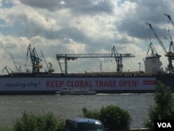 Germany chose the port city of Hamburg as the site of this year's G-20 summit, opening Friday, as a sign that the country remains open in the face of what some perceive as growing isolationism and protectionist trade policies. The giant placard, which reads "Hamburg Ahoy! Keep global trade open!", was spearheaded by the New Social Market Economy Initiative, which describes itself as a cross-party NGO that supports a social market economy with fair competition and redistribution of wealth. (L. Ramirez/VOA)