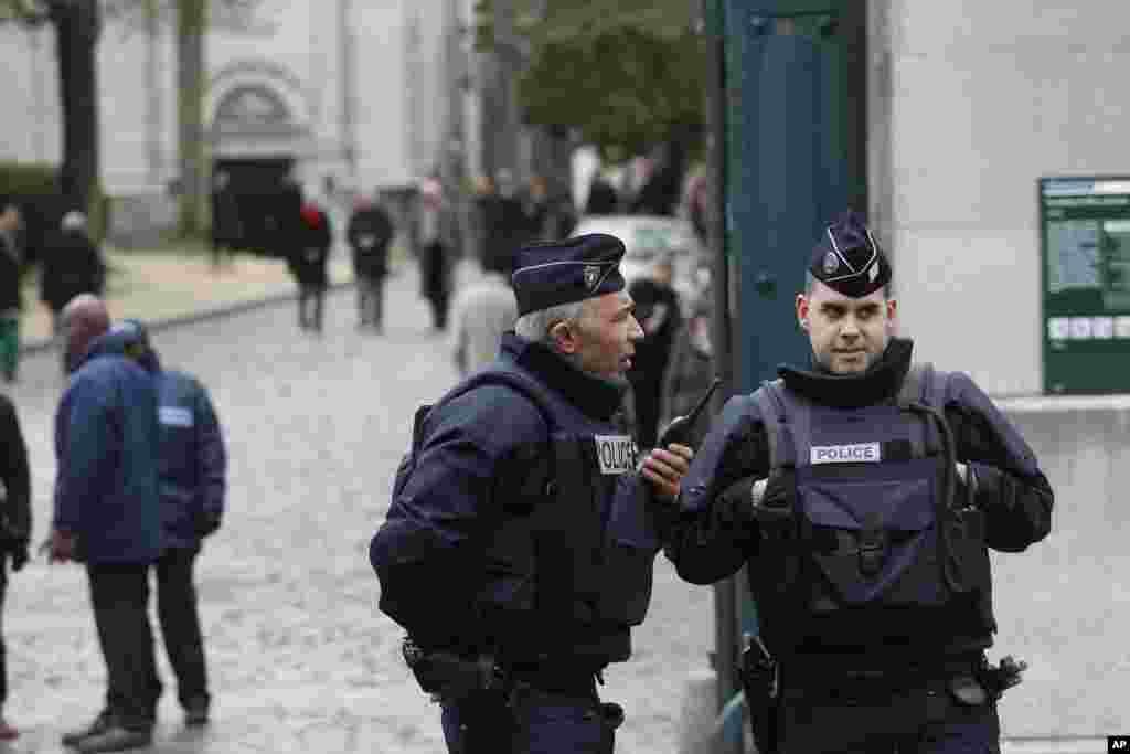 Policemen guard the entrance of the Pere Lachaise cemetery during the funeral of French cartoonist Georges Wolinski, in Paris, France, Jan. 15, 2015.