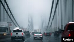 FILE - Cars make their way through the George Washington Bridge in New York City. 