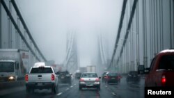 FILE - Cars make their way over the George Washington bridge in New York City in 2014.