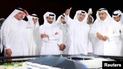 FILE - Secretary-General Hassan al-Thawadi (3rd L) of Qatar's Supreme Committee for Delivery and Legacy, the nation's 2022 World Cup organizing committee, speaks during a news conference to announce the start of work on the al-Khor Stadium, June 21, 2014. 