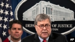 U.S. Attorney General William Barr, right, with FBI Deputy Director David Bowdich standing behind him, speaks during a news conference at the U.S. Department of Justice, in Washington, Feb. 10, 2020.