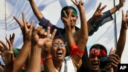 Bangladeshi youth gesture while celebrating the death sentence of Jamaat-e-Islami leader Delwar Hossain Sayedee in Dhaka, Bangladesh, February 28, 2013.