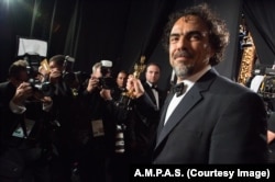 FILE - 'Birdman' director Alejandro Iñárritu appears backstage at the Academy Awards.