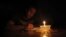Mostafa Khaled, 20, studies by candlelight for his early morning exams during a power cut in Toukh, about 25 km northeast of Cairo, May 26, 2013.