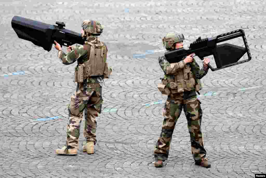 French Army soldiers hold anti-drone guns during the traditional Bastille Day military parade on the Champs-Elysees Avenue in Paris.