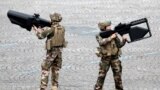 French Army soldiers hold anti-drone guns during the traditional Bastille Day military parade on the Champs-Elysees Avenue in Paris.