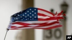 Una bandera estadounidense rasgada por los vientos del huracán Matthew en St. Agustin, Florida.