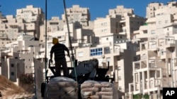 A construction worker works on a new housing unit in the east Jerusalem neighborhood of Har Homa. (File)