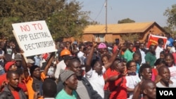 FILE - Demonstrators march along a street protesting May election results during a rally in Malawi's capital Lilongwe. Despite the coronavirus spread, a re-run of the vote is now scheduled for July. (Lameck Masina/VOA)