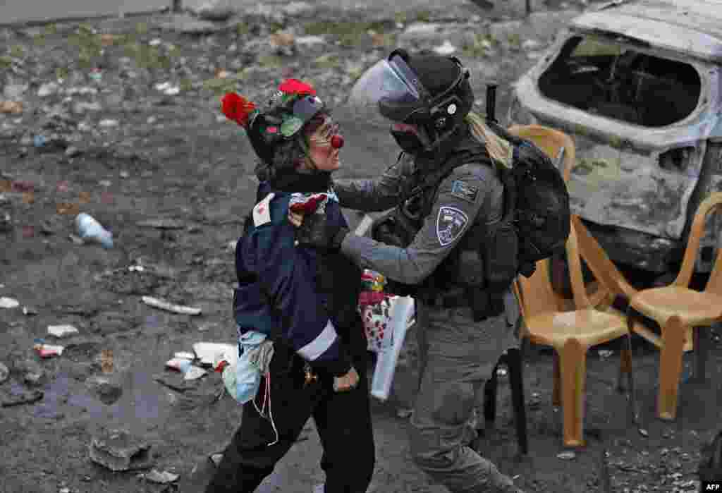 A protester scuffles with a member of Israeli security forces during a demonstration in the east Jerusalem neighborhood of Sheikh Jarrah.