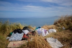 Mattresses and belongings of migrants sit atop a hill in the Spanish enclave of Ceuta, near the border of Morocco and Spain, May 21, 2021.