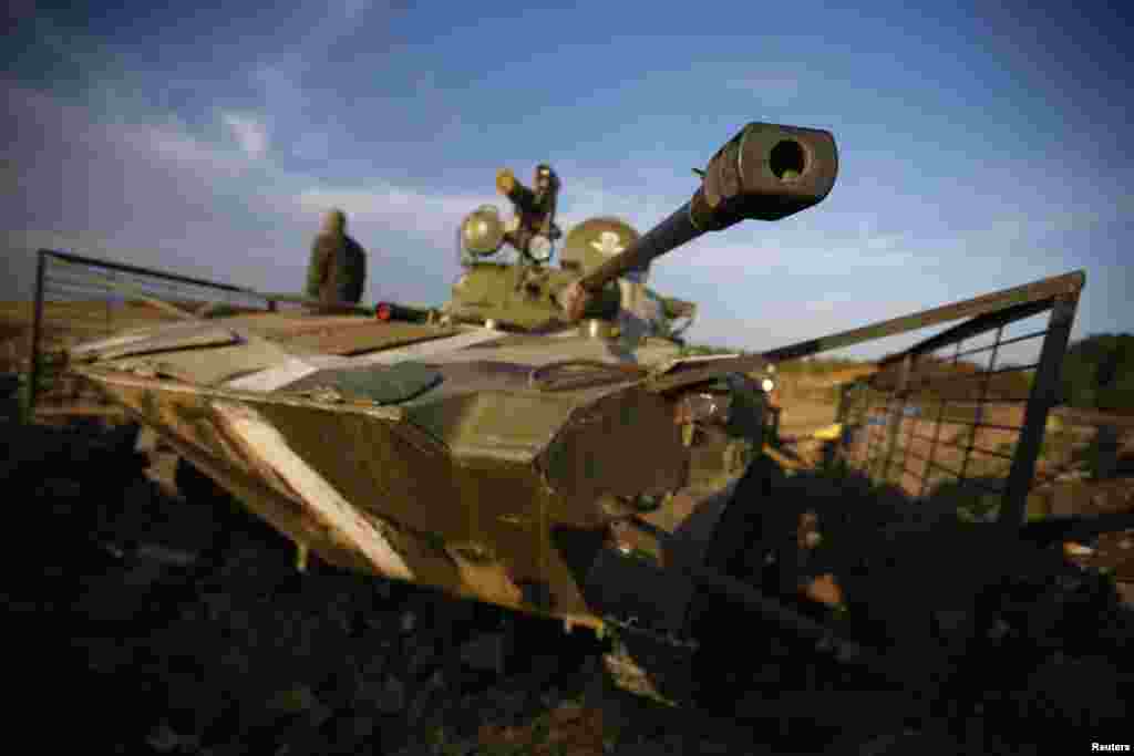 A Ukrainian soldier is pictured next to a tank near the village of Debaltseve in eastern Ukraine Sept. 21, 2014.