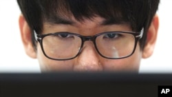 FILE - Simon Choi, a South Korean cybersecurity researcher, watches his personal computer during an interview in Seoul, South Korea. 