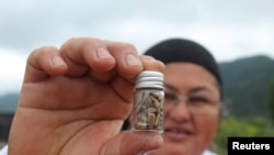 Mapuche native cook and farmer Ana Yanez Antillanca, known as a 'Seed guardian', shows 'egg pumpkin' seeds as she meets with comrades to exchange forgotten vegetables varieties, in Rancagua, Chile, Oct. 11, 2024.