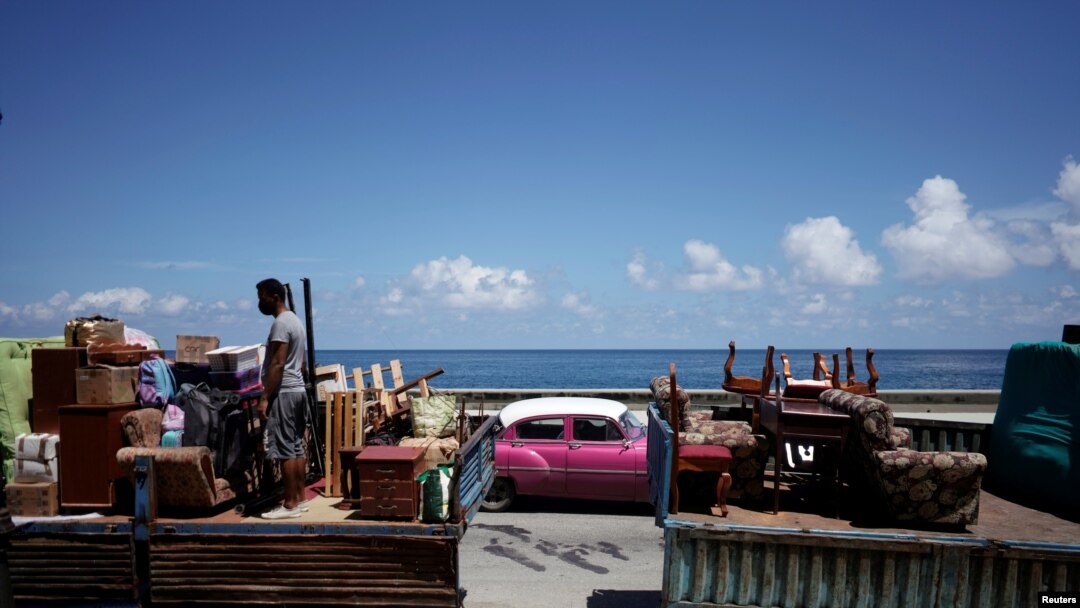 A man loads a truck with furniture to be relocated prior to the anticipated arrival of Tropical Storm Elsa, in Havana, Cuba, July 4, 2021.