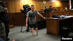 Paralympic gold medalist Oscar Pistorius walks across the courtroom without his prosthetic legs during the third day of his resentencing hearing for the 2013 murder of his girlfriend Reeva Steenkamp in the North Gauteng High Court in Pretoria, June 15, 20