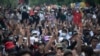 Demonstran pro-demokrasi memberikan "salam tiga jari", simbol perlawanan, saat melakukan aksi protes di luar gedung parlemen di Bangkok, Thailand, Kamis, 24 September 2020. (AP Photo/Sakchai Lalit)