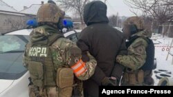 This handout photograph taken from the official Facebook account of the Ukrainian Ministry of Internal Affairs on Jan. 27, 2022, shows the arrest of Artemiy Ryabchuk in Dnipro.