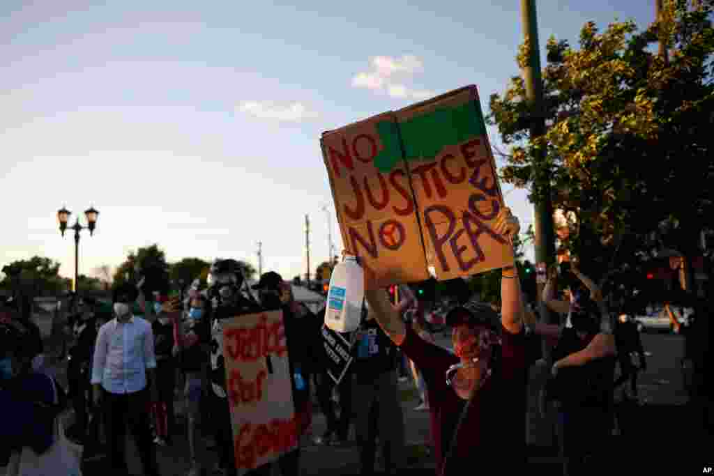 Demonstrators gather, May 28, 2020, in St. Paul, Minn. Protests over the death of George Floyd, the black man who died in police custody broke out in Minneapolis for a third straight night. 