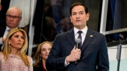 Newly confirmed U.S. Secretary of State Marco Rubio, with his wife, Jeanette Dousdebes Rubio, speaks at the State Department in Washington, Jan. 21, 2025.