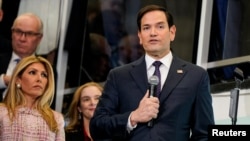 Newly confirmed U.S. Secretary of State Marco Rubio, with his wife, Jeanette Dousdebes Rubio, speaks at the State Department in Washington, Jan. 21, 2025.