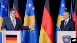 German Foreign Minister Sigmar Gabriel, left, gestures next to Kosovo's Prime Minister Isa Mustafa during a press conference in Kosovo's capital Pristina, April 13, 2017. 