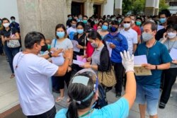 People wait to be inoculated with a dose of a COVID-19 coronavirus vaccine at the Holy Redeemer Catholic church in Bangkok on May 10, 2021.