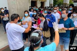 People wait to be inoculated with a dose of a COVID-19 coronavirus vaccine at the Holy Redeemer Catholic church in Bangkok on May 10, 2021.
