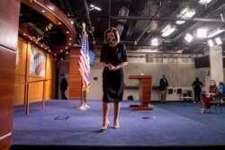 FILE - House Speaker Nancy Pelosi of Calif., wears a mask as she steps away from the podium at the conclusion of a news conference on Capitol Hill, May 14, 2020, in Washington.