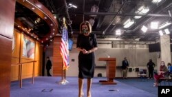 House Speaker Nancy Pelosi of California wears a mask as she steps away from the podium after a news conference on Capitol Hill, on May 14, 2020, in Washington, D.C.