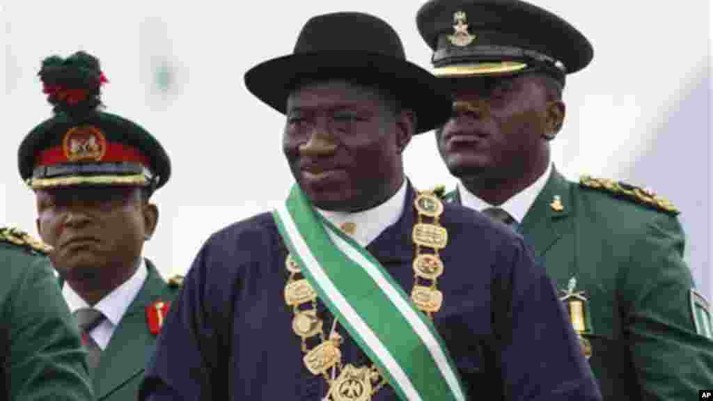 Nigerian President Goodluck Jonathan, center, inspects a guard of honor during his inauguration ceremony at the main parade ground in Nigeria&#39;s capital of Abuja, Sunday, May 29, 2011.