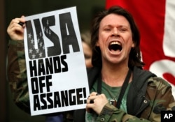 British activist Lauri Love protests at the entrance of Westminster Magistrates Court in London, May 2, 2019. WikiLeaks founder Julian Assange is facing a court hearing over a U.S. request to extradite him for allegedly conspiring to hack a Pentagon computer.