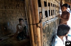 FILE - 17-year old Rorbiza rests at home of Dapaing, North of Sittwe, western Rakhine state, Myanmar after escaping from a human trafficking boat.