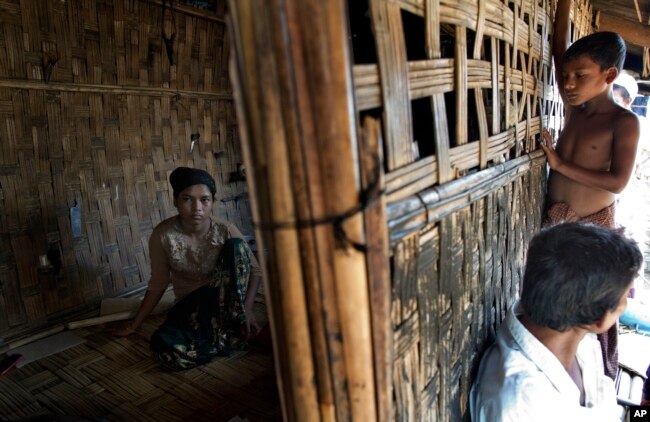 Seventeen-year old Rorbiza (L) rests at home in Dapaing, western Rakhine state, Myanmar, May 12, 2015, after escaping from a human trafficking boat. Some 21 million people are estimated to be used in forced labor or as sex slaves, coerced into prostitution or involuntarily recruited into armed groups.