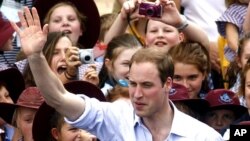 Britain's Prince William waves to residents as he leaves Kerang, March 21, 2011