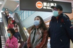 People wear masks at a metro station in Taipei, Taiwan, Tuesday, Jan. 28, 2020.