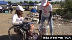 Candice Cable helps pick up trash from the Los Angles River, April 15, 2017. Cable, a member of the committee to bring the Olympic Games to Los Angeles, says the volunteer-run program to bring the Summer Games to the city in 2024 hopes to “get future volu