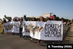 A group of young Tanzanians march in the ‘Walk for Elephants’ event in Dar es Salaam, Tanzania, Jan. 14, 2017.
