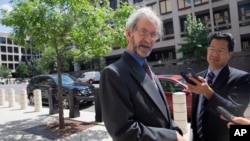 Douglas Hughes, the gyrocopter pilot who landed on the west front of the U.S. Capitol, talks with reporters outside of Federal Court after a status hearing in Washington, June 22, 2015.