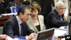 High Representative of the European Union for Foreign Affairs and Security Policy Catherine Ashton (R) speaks with NATO Secretary General Anders Fogh Rasmussen before a Defense Council meeting at the European Union headquarters in Brussels, 9 Dec 2010