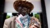 FILE- A man from South Sudan displays new currency notes outside the Central Bank of South Sudan in Juba, July 18, 2011.